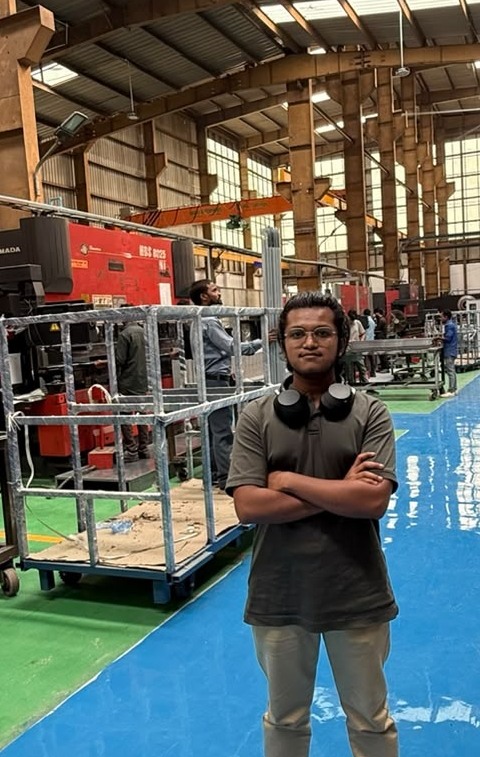 Aryan Goud Kovelakonda on a sheet-metal factory floor